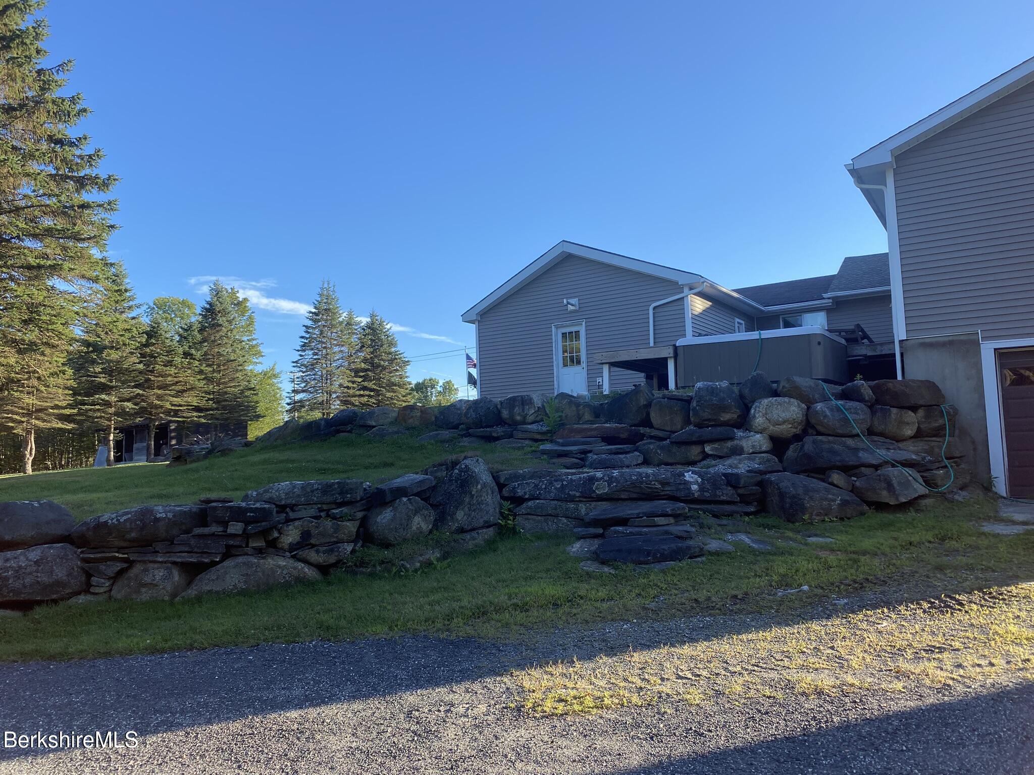 554 Main Street Becket, MA 01223 - Photo 26 of 36 a view of a house with a big yard plants and large trees