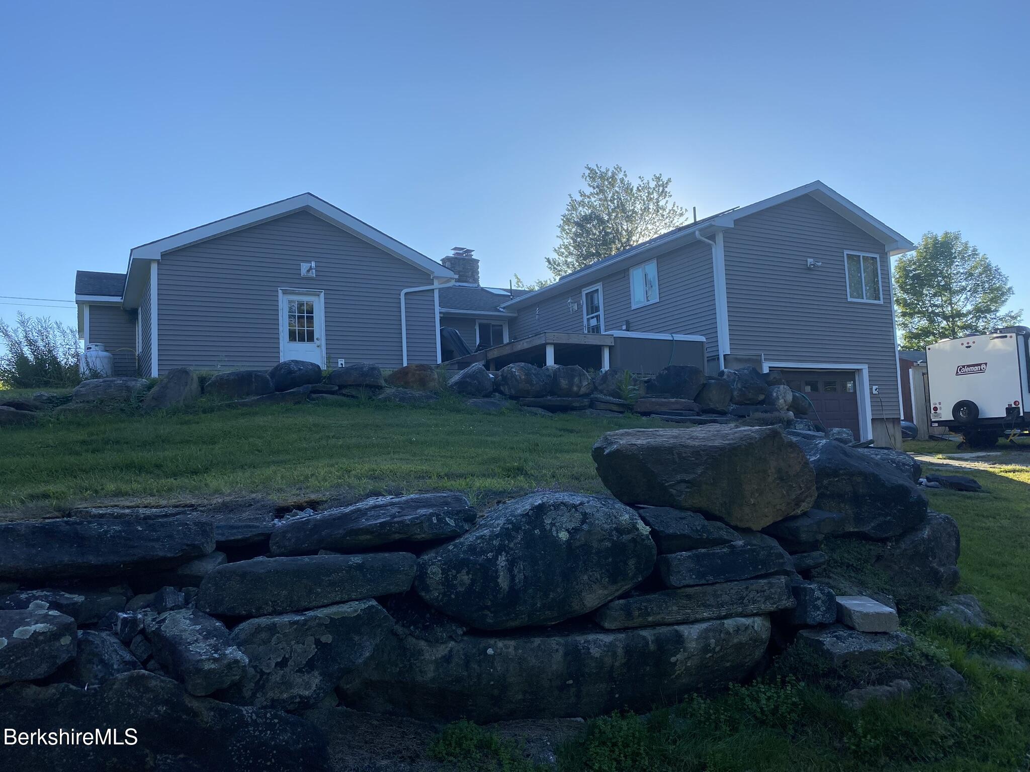 554 Main Street Becket, MA 01223 - Photo 27 of 36 a view of a house with backyard and garden