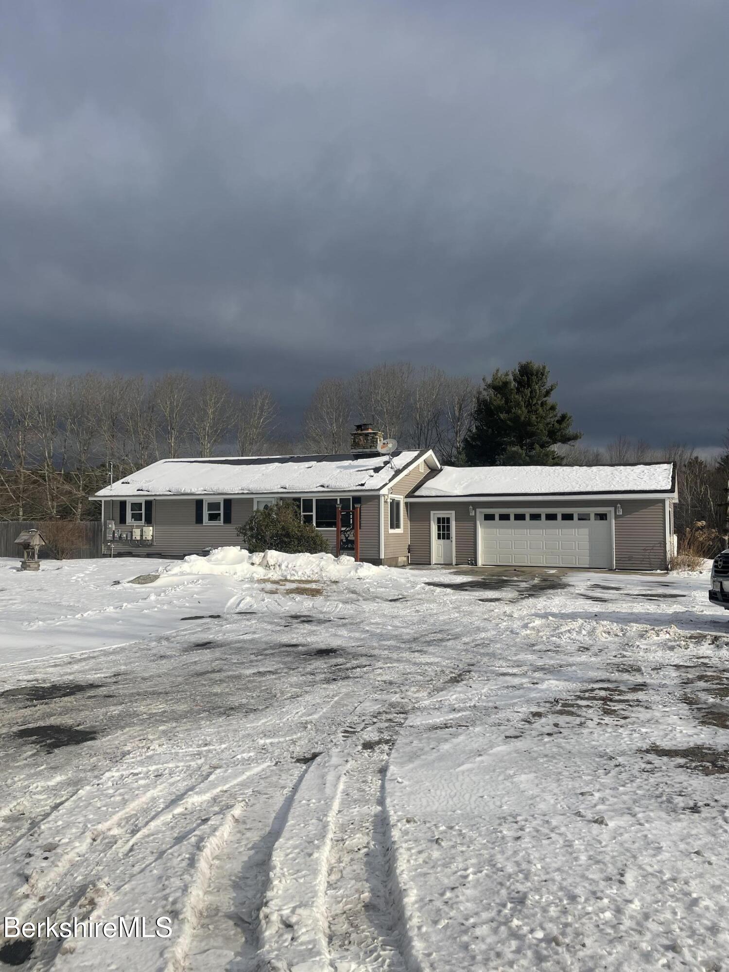554 Main Street Becket, MA 01223 - Photo 32 of 36 a front view of a house with a yard