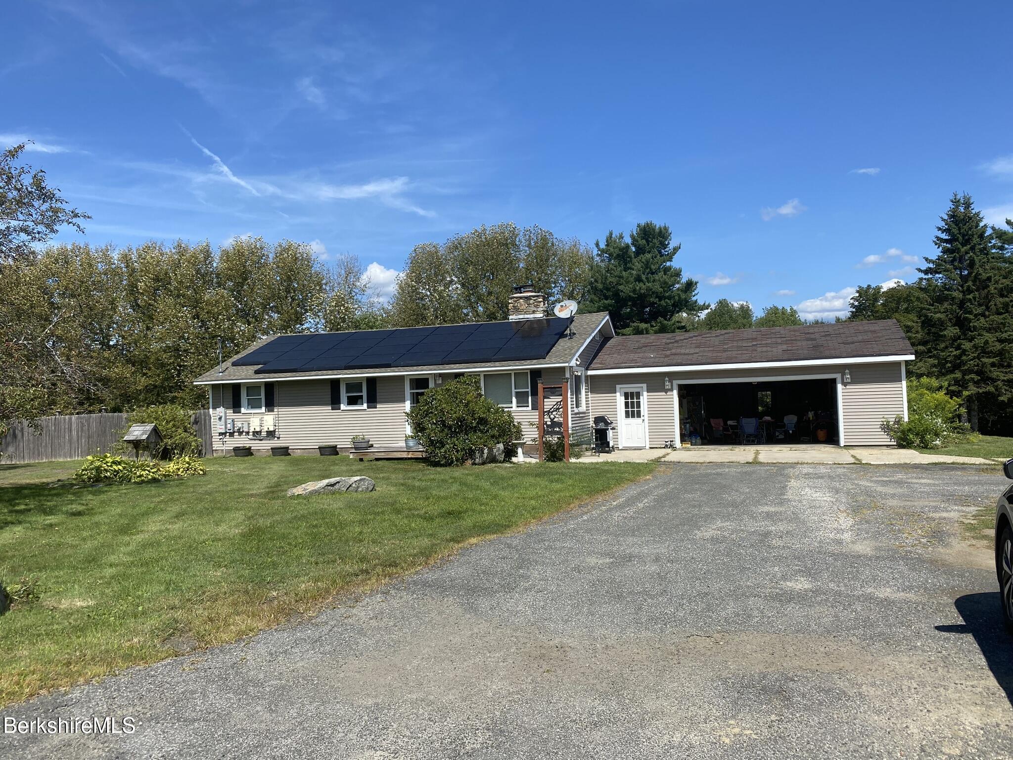 554 Main Street Becket, MA 01223 - Photo 4 of 36 a front view of a house with a garden