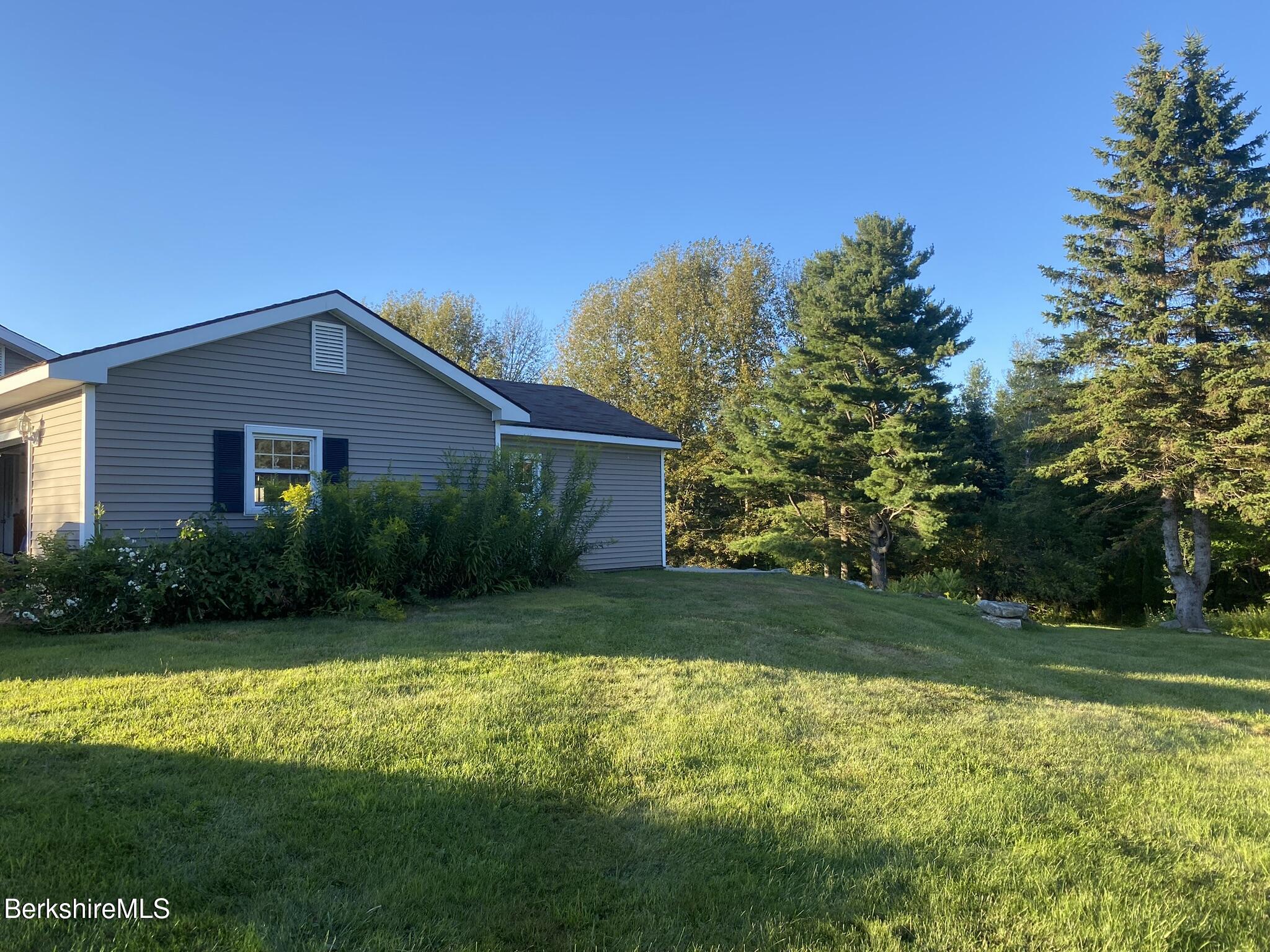 554 Main Street Becket, MA 01223 - Photo 8 of 36 a front view of house with yard and green space