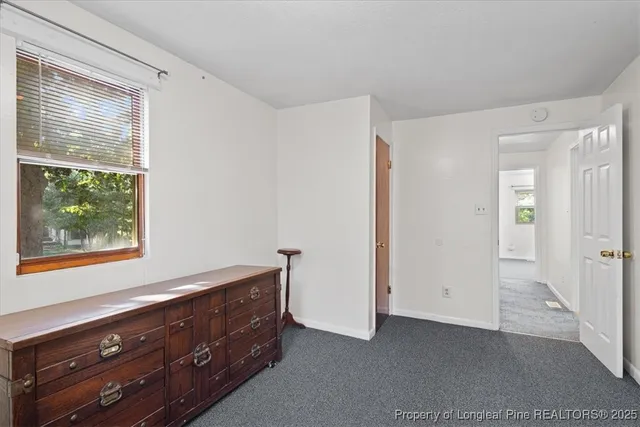 a room with a dresser and a window