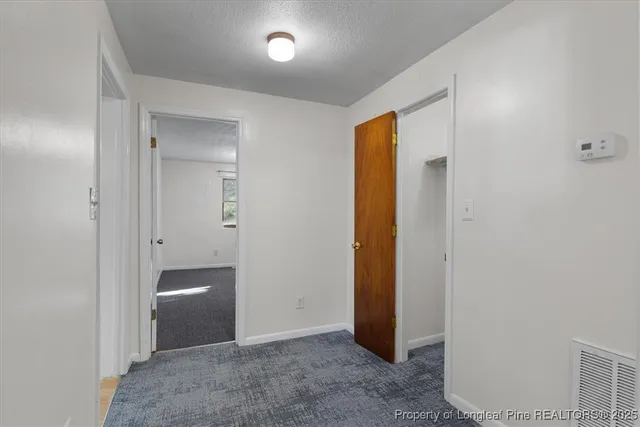 a view of an empty room and closet area