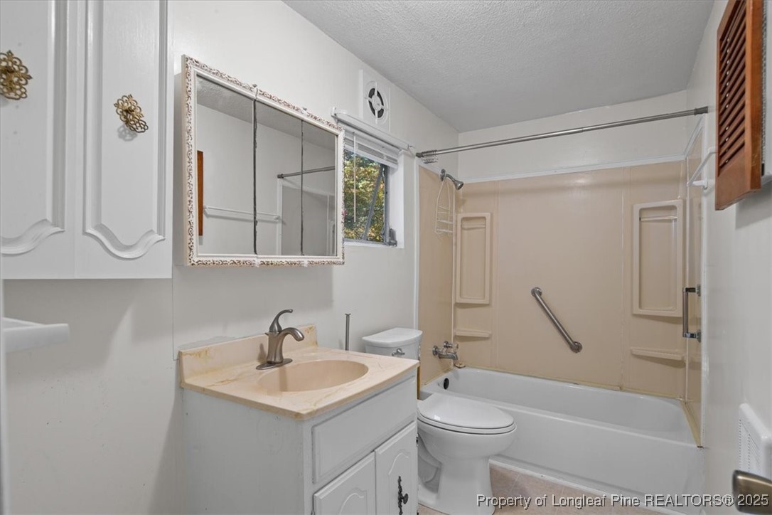 663 Possum Holler Road Eagle Springs, NC 27242 - Photo 15 of 21 a bathroom with a sink a toilet and shower