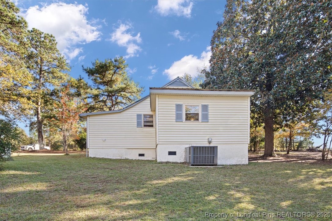 663 Possum Holler Road Eagle Springs, NC 27242 - Photo 2 of 21 a view of a white house with a big yard and large tree