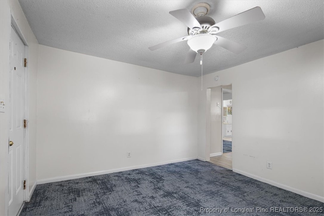 663 Possum Holler Road Eagle Springs, NC 27242 - Photo 4 of 21 a view of a chandelier fan in a room