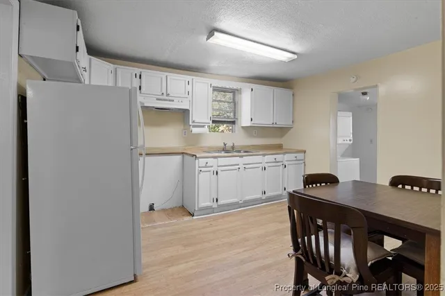 a kitchen with stainless steel appliances a refrigerator and a stove top oven