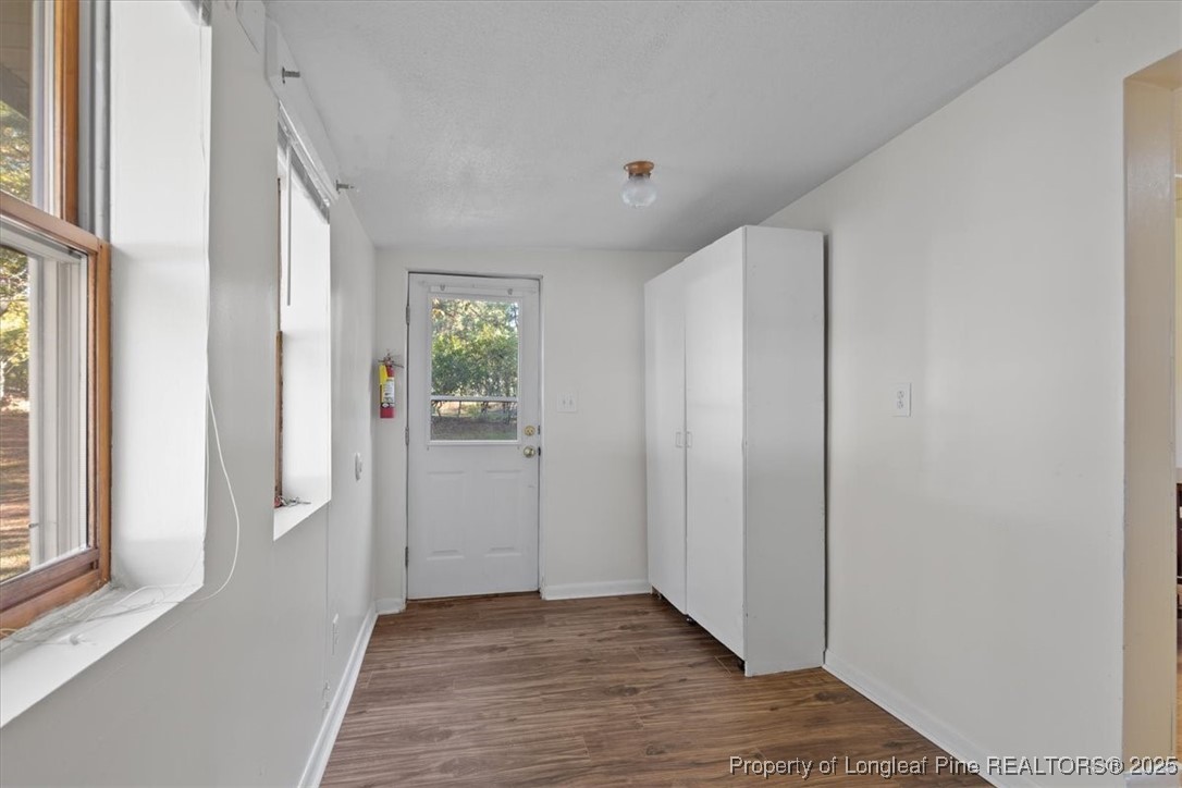 663 Possum Holler Road Eagle Springs, NC 27242 - Photo 9 of 21 a view of an empty room with wooden floor and a window