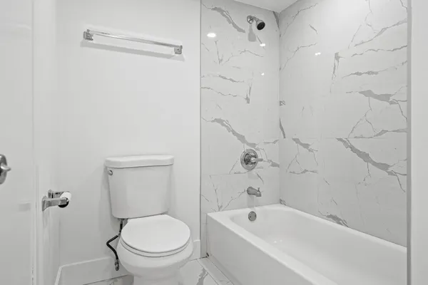 a bathroom with a toilet and a bathtub