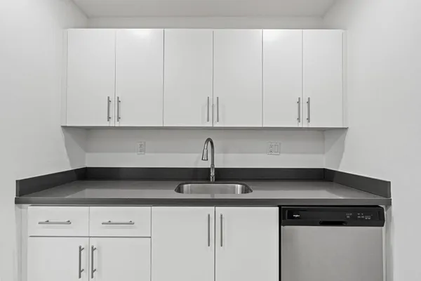 a kitchen with a sink and cabinets