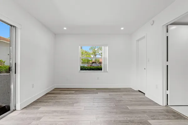 a view of room with window and wooden floor