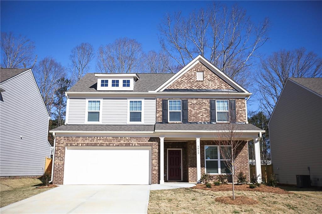 5949 Wheeler Ridge Road Auburn, GA 30011 - Photo 1 of 1 a view of a brick house with large windows