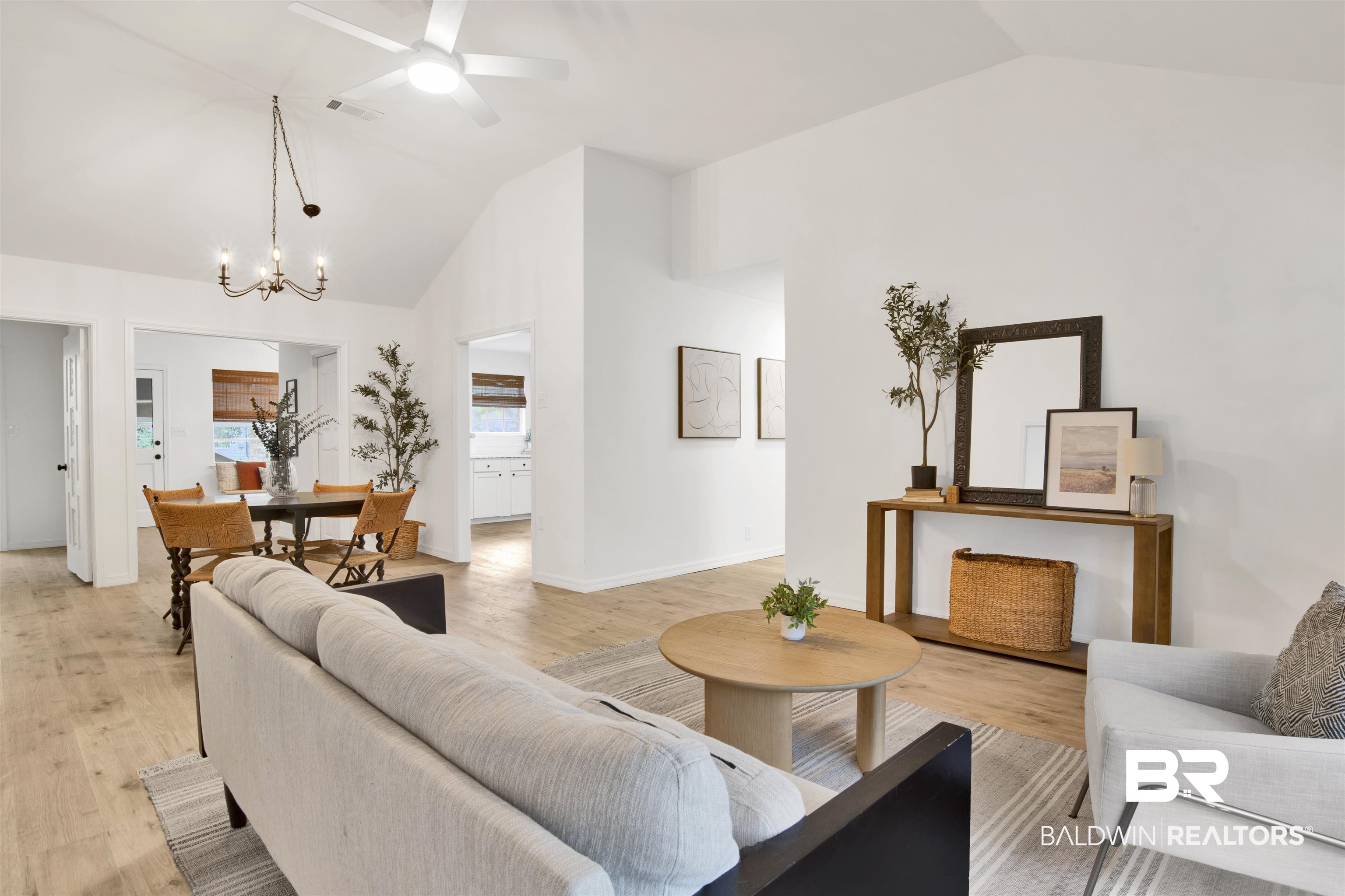 317 Lee Street Chickasaw, AL 36611 - Photo 6 of 40 Living room with ceiling fan, light wood-type flooring, a chandelier, and high vaulted ceiling