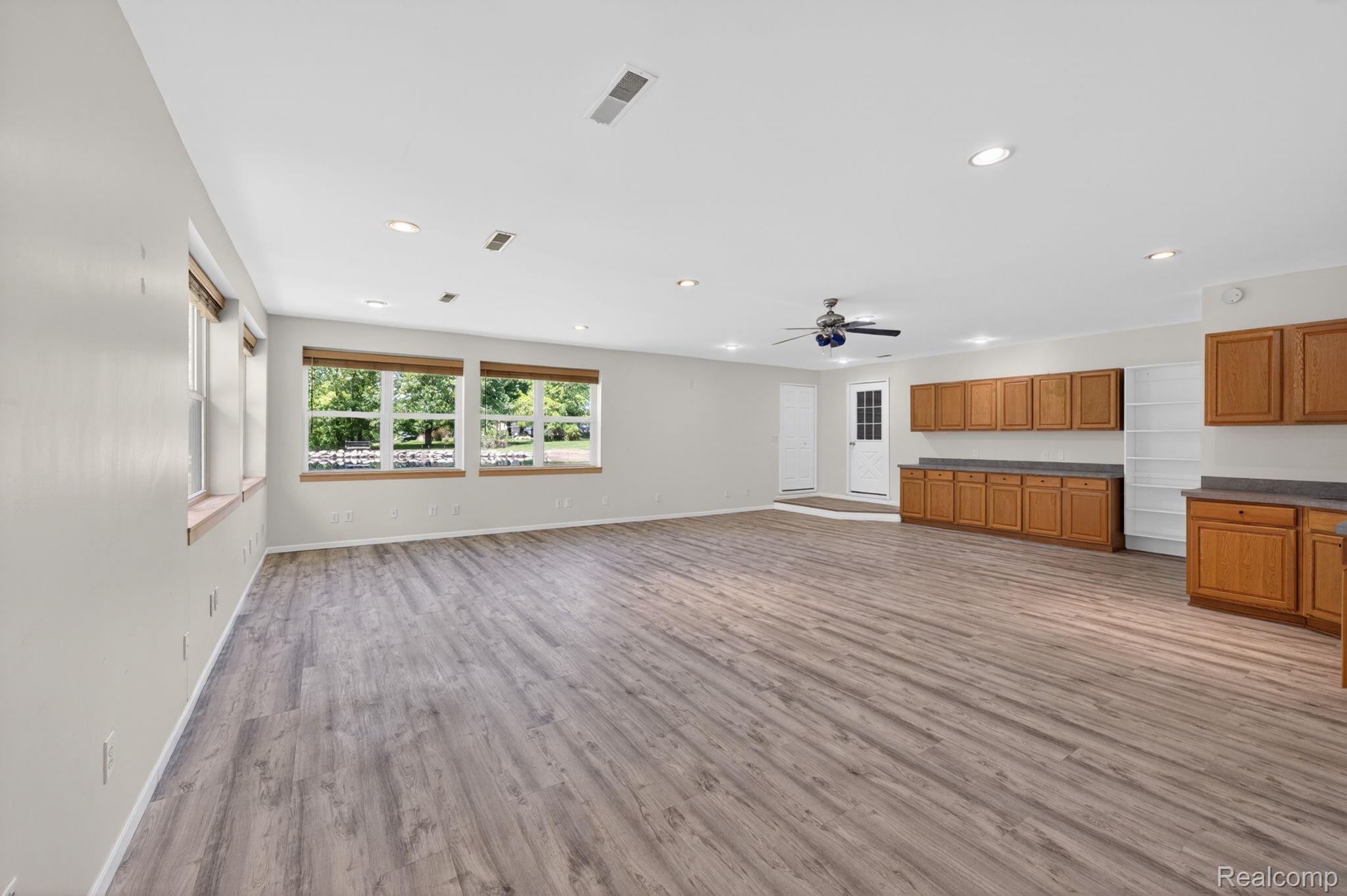 9353 Hill Road Swartz Creek, MI 48473 - Photo 80 of 98 Spacious open-concept room featuring wood-finish flooring, ample natural light from multiple windows, recessed lighting, and a ceiling fan