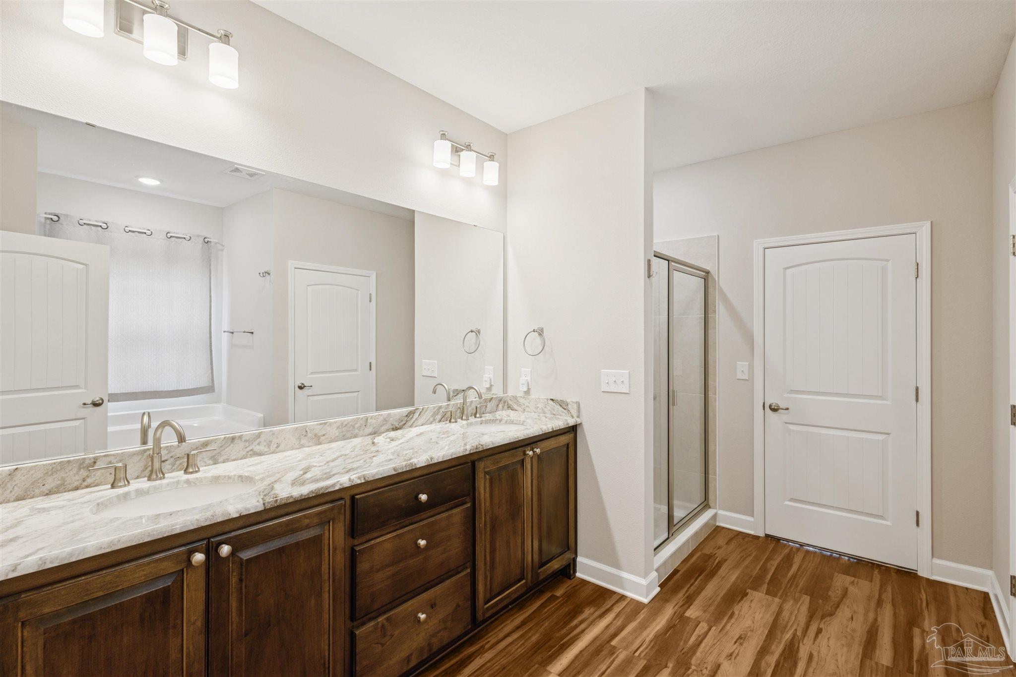 9855 Shangri La West Road Milton, FL 32583 - Photo 18 of 32 a bathroom with a granite countertop sink mirror and double