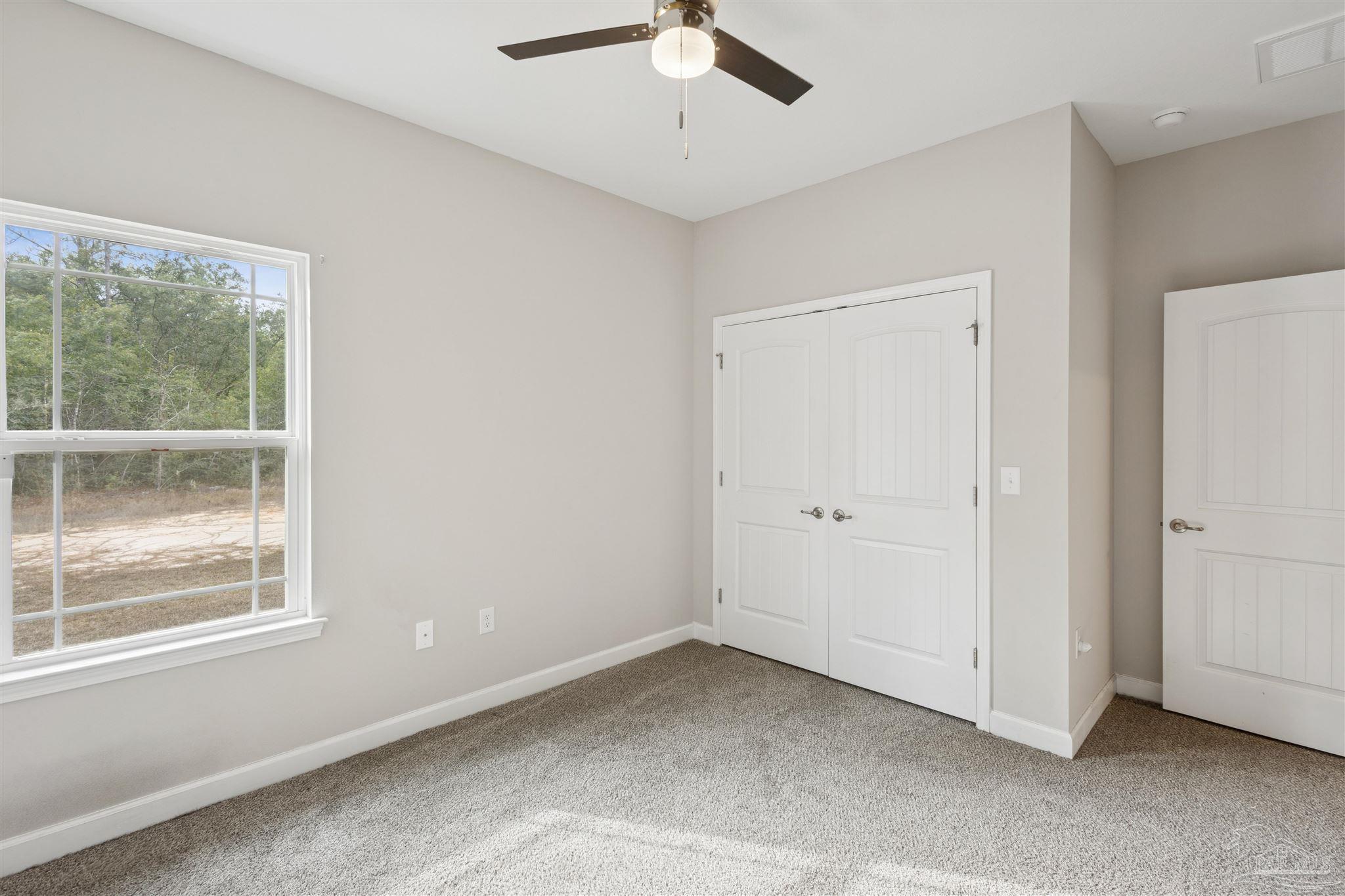 9855 Shangri La West Road Milton, FL 32583 - Photo 22 of 32 a view of a livingroom with a window