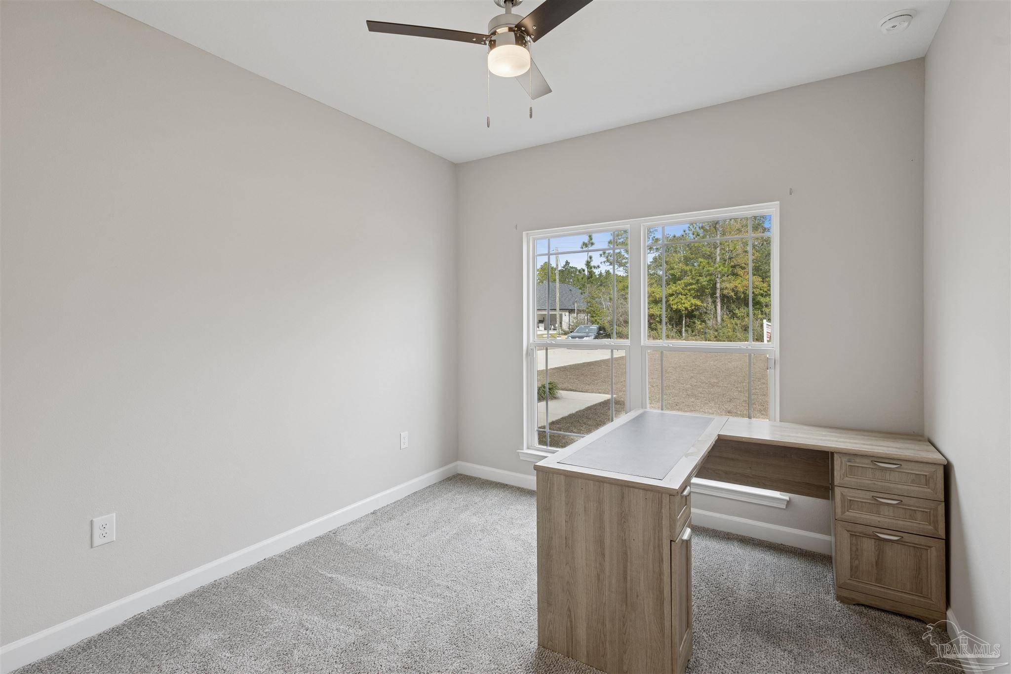 9855 Shangri La West Road Milton, FL 32583 - Photo 28 of 32 a living room with furniture and a window