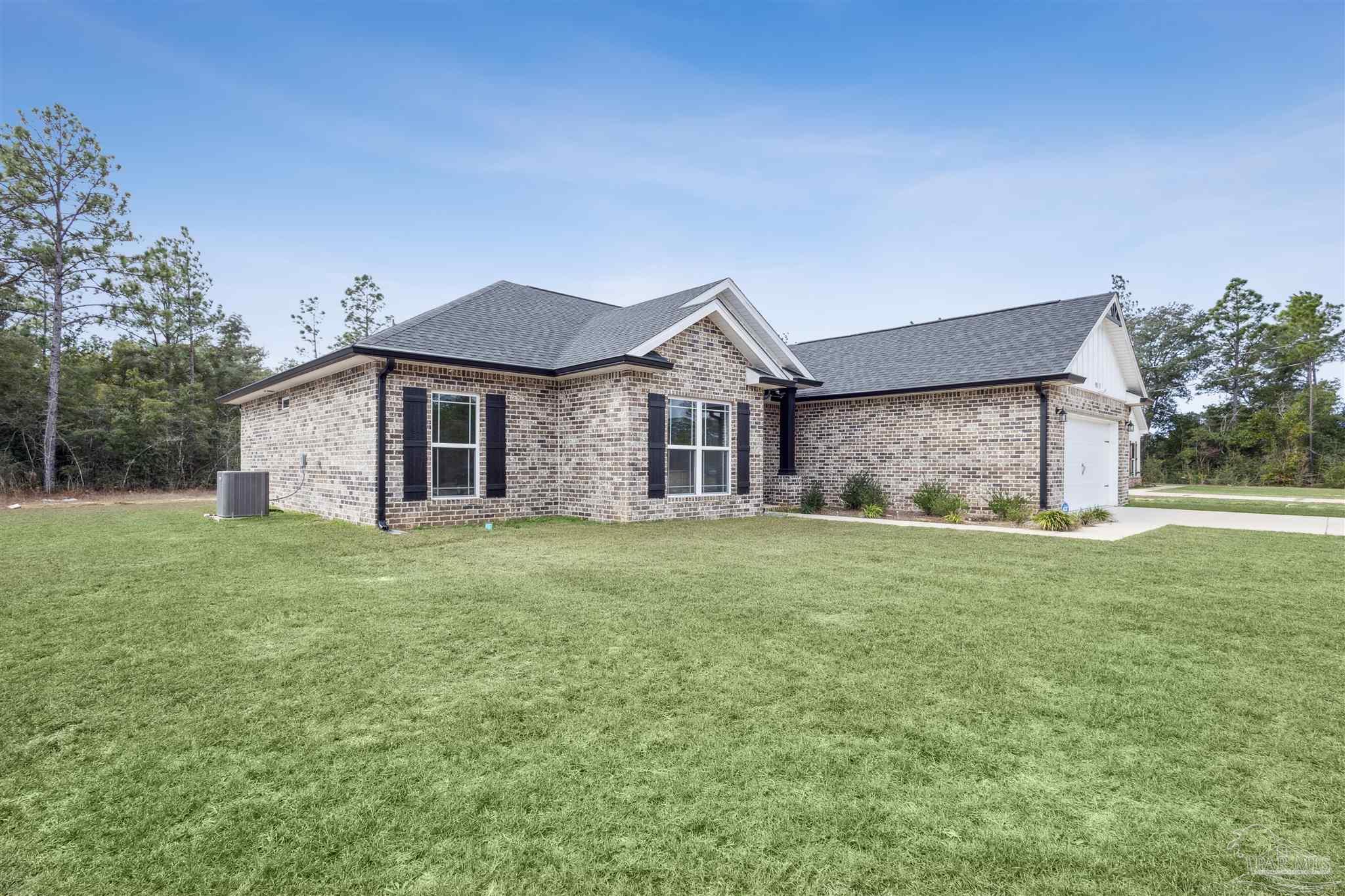 9855 Shangri La West Road Milton, FL 32583 - Photo 3 of 32 a view of a house with a yard