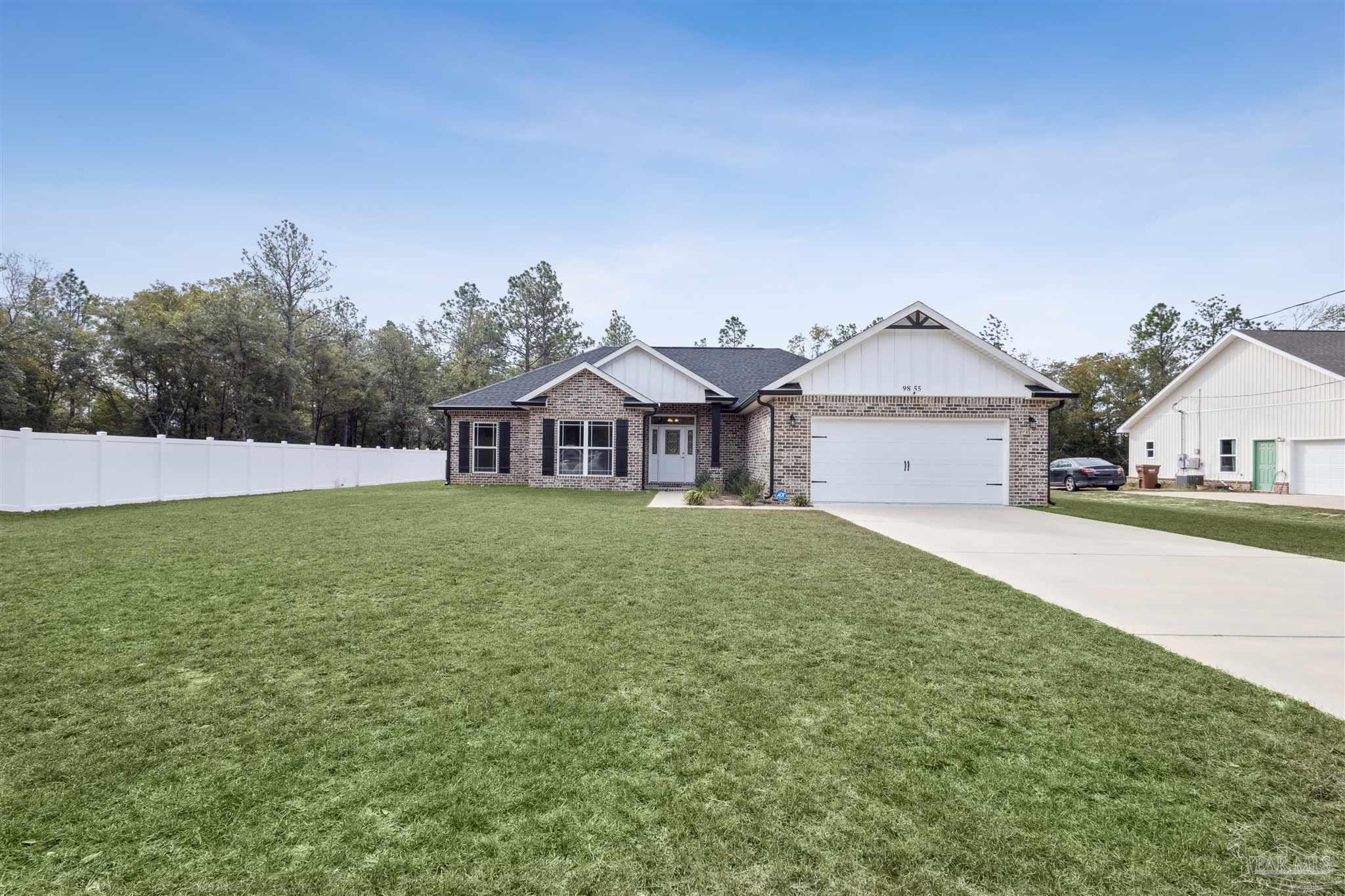 9855 Shangri La West Road Milton, FL 32583 - Photo 32 of 32 a front view of a house with garden