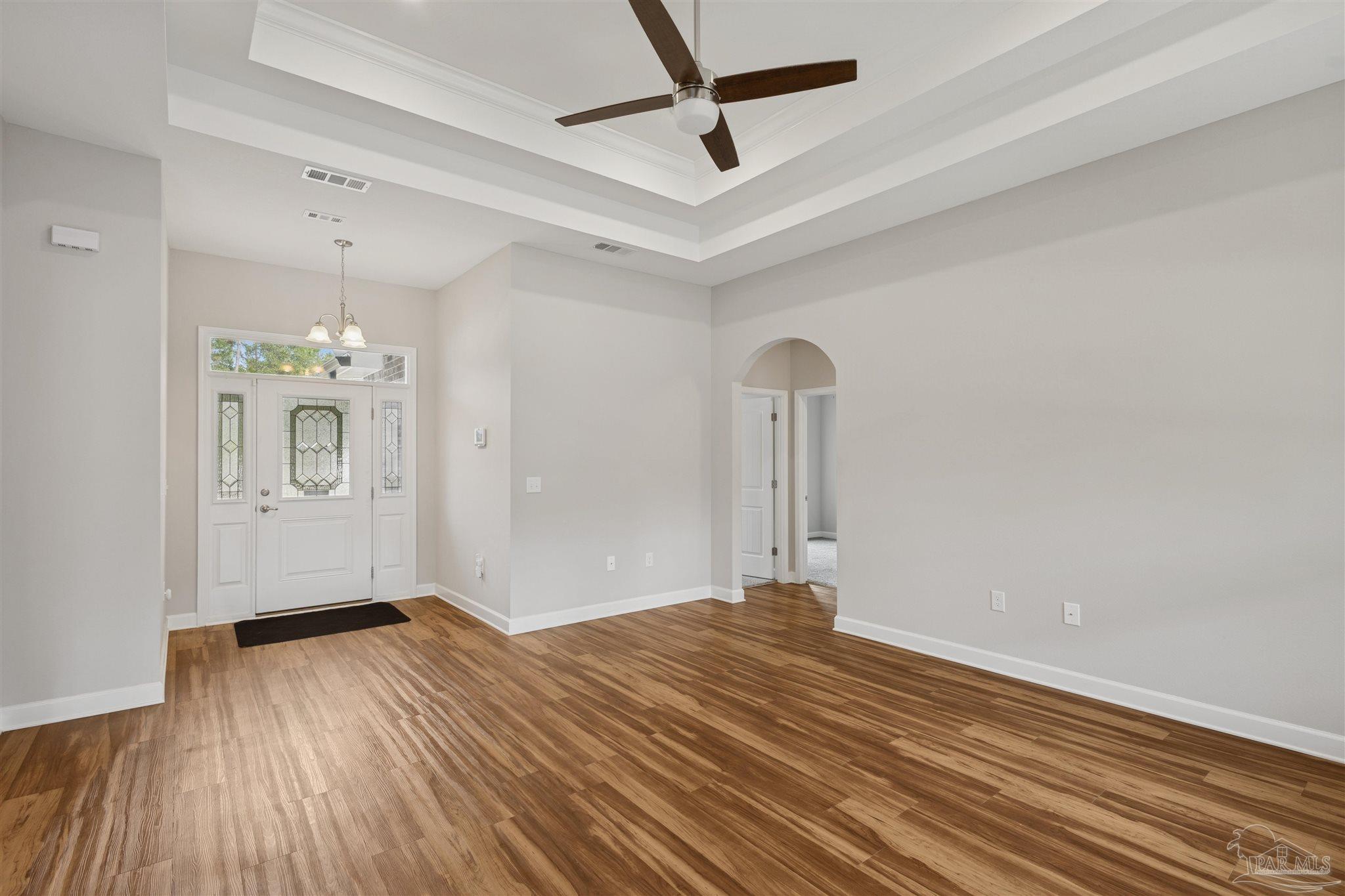 9855 Shangri La West Road Milton, FL 32583 - Photo 4 of 32 a view of a livingroom with wooden floor and a ceiling fan