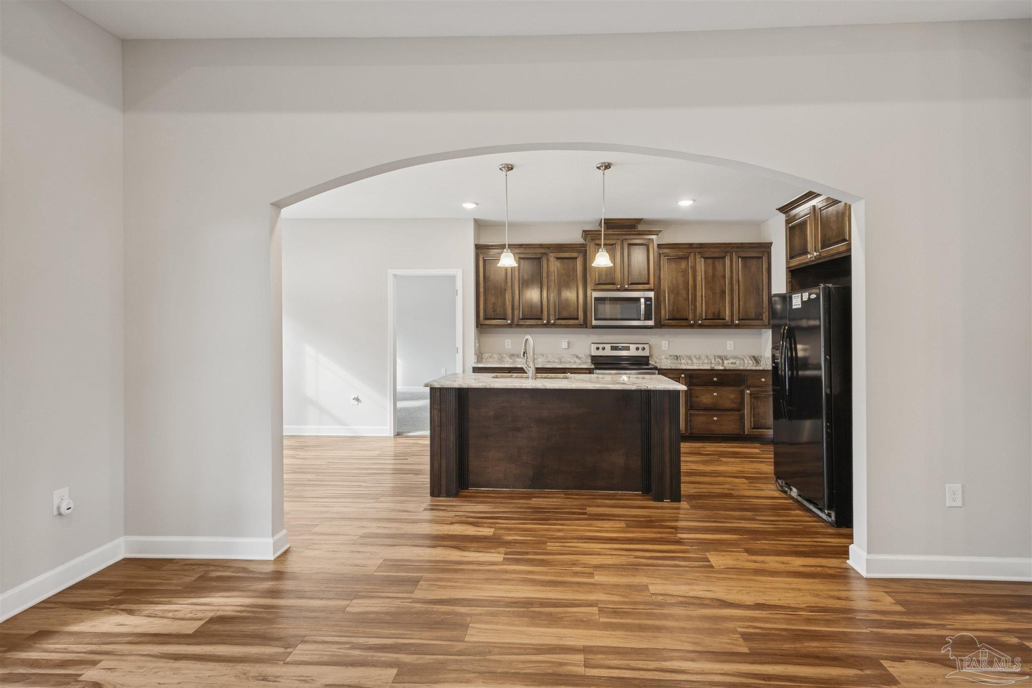 9855 Shangri La West Road Milton, FL 32583 - Photo 9 of 32 a view of kitchen with kitchen island microwave and cabinets