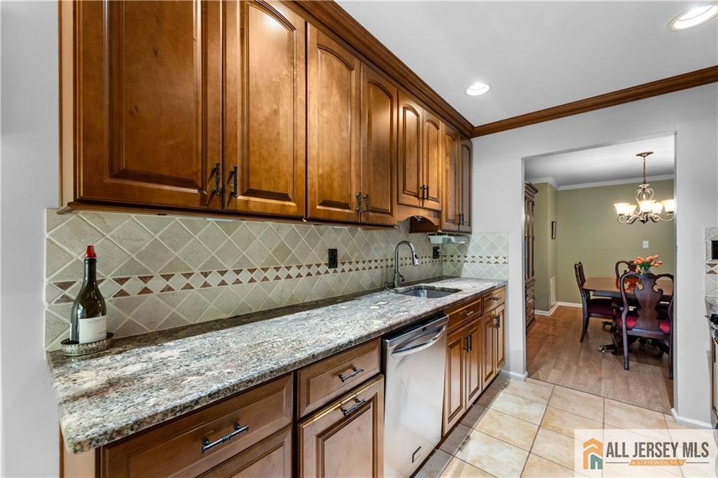 28 Garfield Way Princeton, NJ 08540 - Photo 15 of 39 a kitchen with granite countertop a sink a stove and cabinets