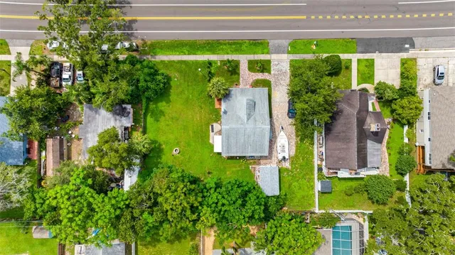 an aerial view of a house with a yard and plants