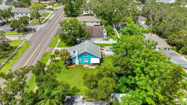 an aerial view of a house with a yard