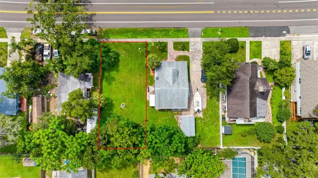 an aerial view of a house with a yard and plants
