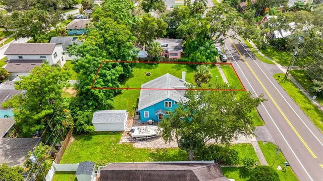 an aerial view of a house with outdoor space