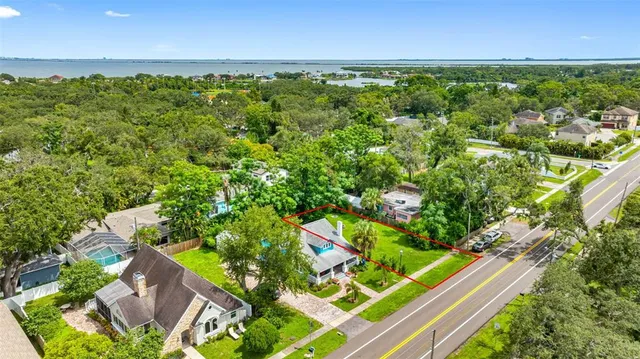 an aerial view of a residential houses with outdoor space and street view