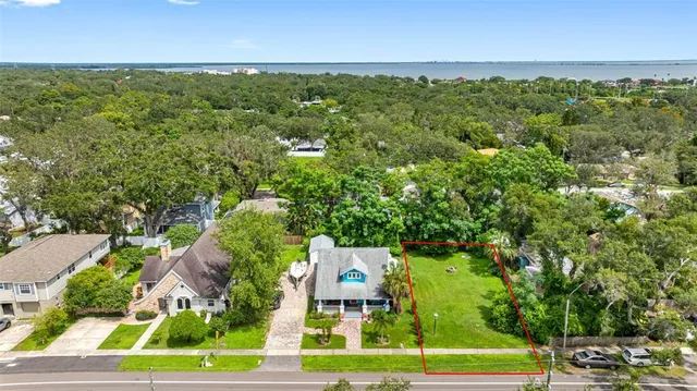 an aerial view of residential houses with outdoor space and street view