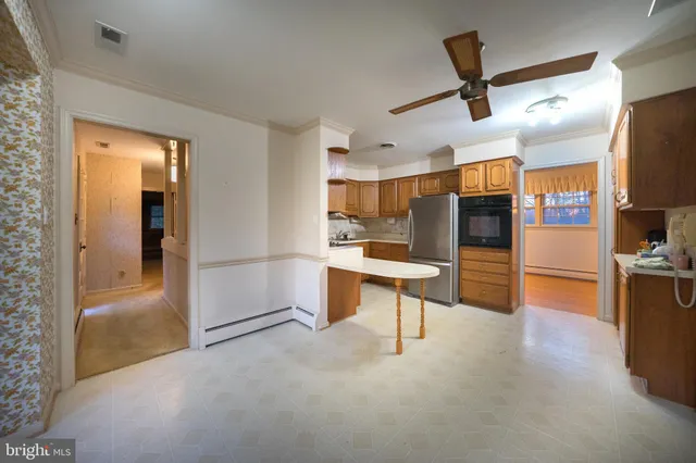 a view of kitchen with furniture and a refrigerator