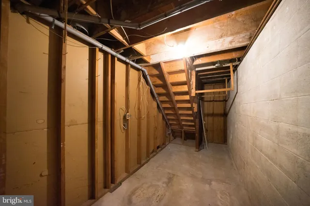a view of a patio with a table and chairs under an umbrella