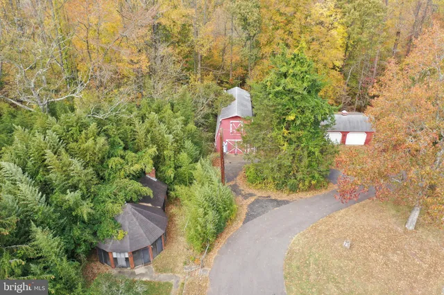 a view of a patio with a table and chairs under an umbrella with a roof