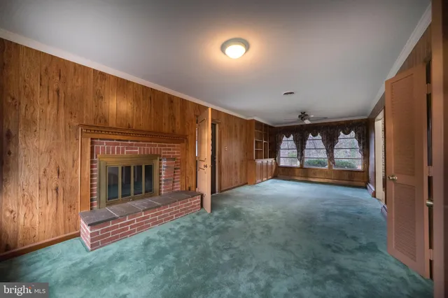 a view of an empty room with a fireplace