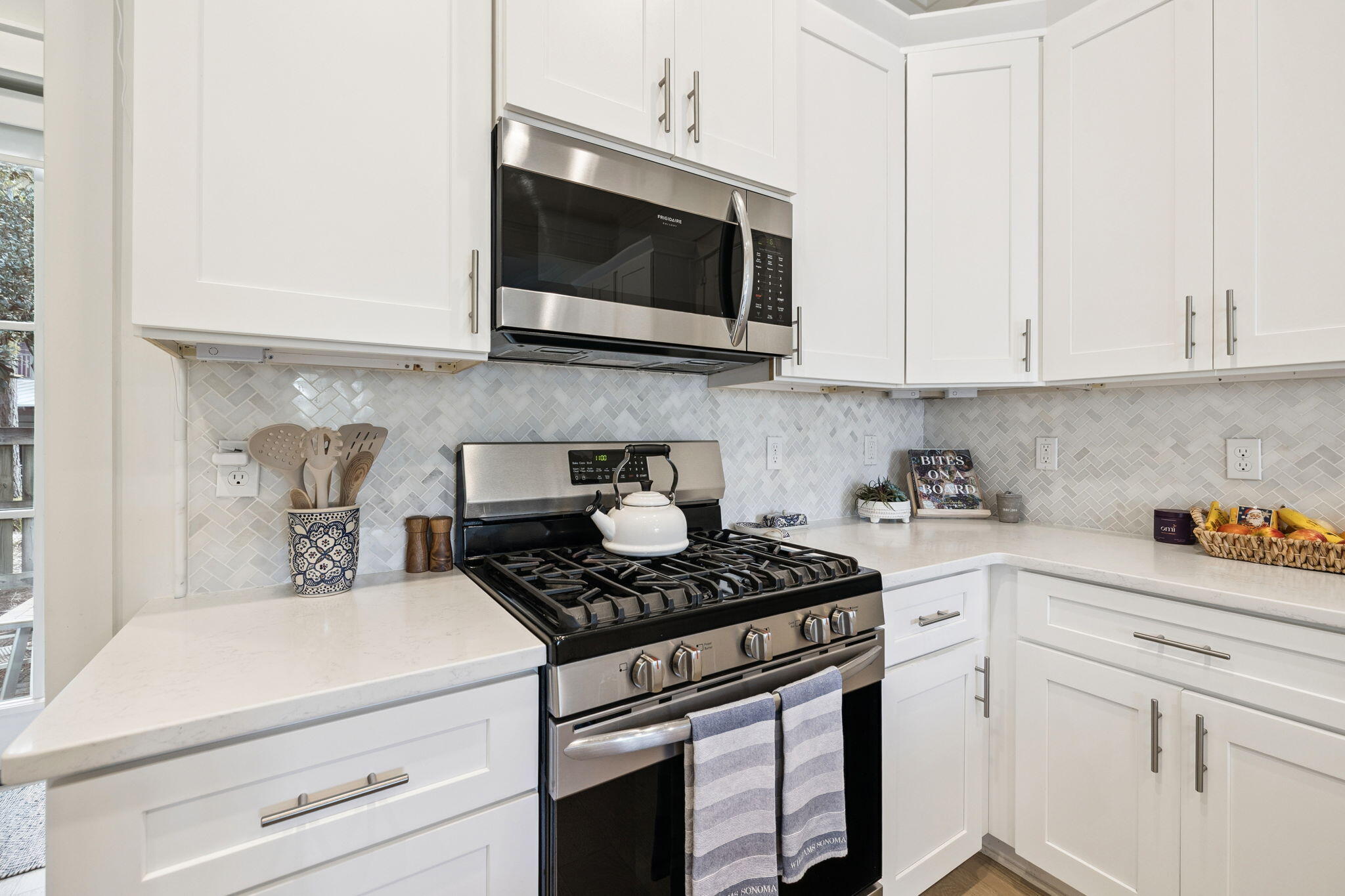 186 Cabana Trail Santa Rosa Beach, FL 32459 - Photo 24 of 51 a kitchen with stainless steel appliances granite countertop a sink a stove and a microwave