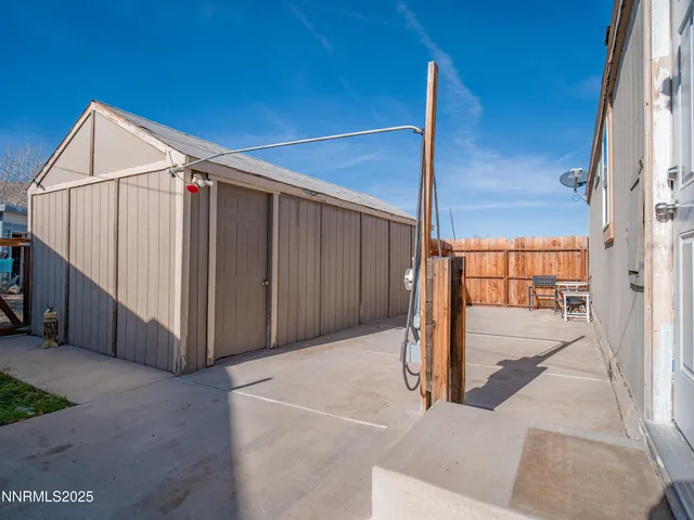 a backyard of a house with barbeque oven and outdoor seating