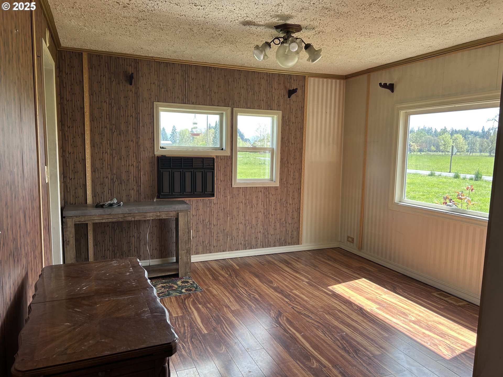 12403 South Eby Road Canby, OR 97013 - Photo 20 of 26 a view of an empty room with a window and wooden floor