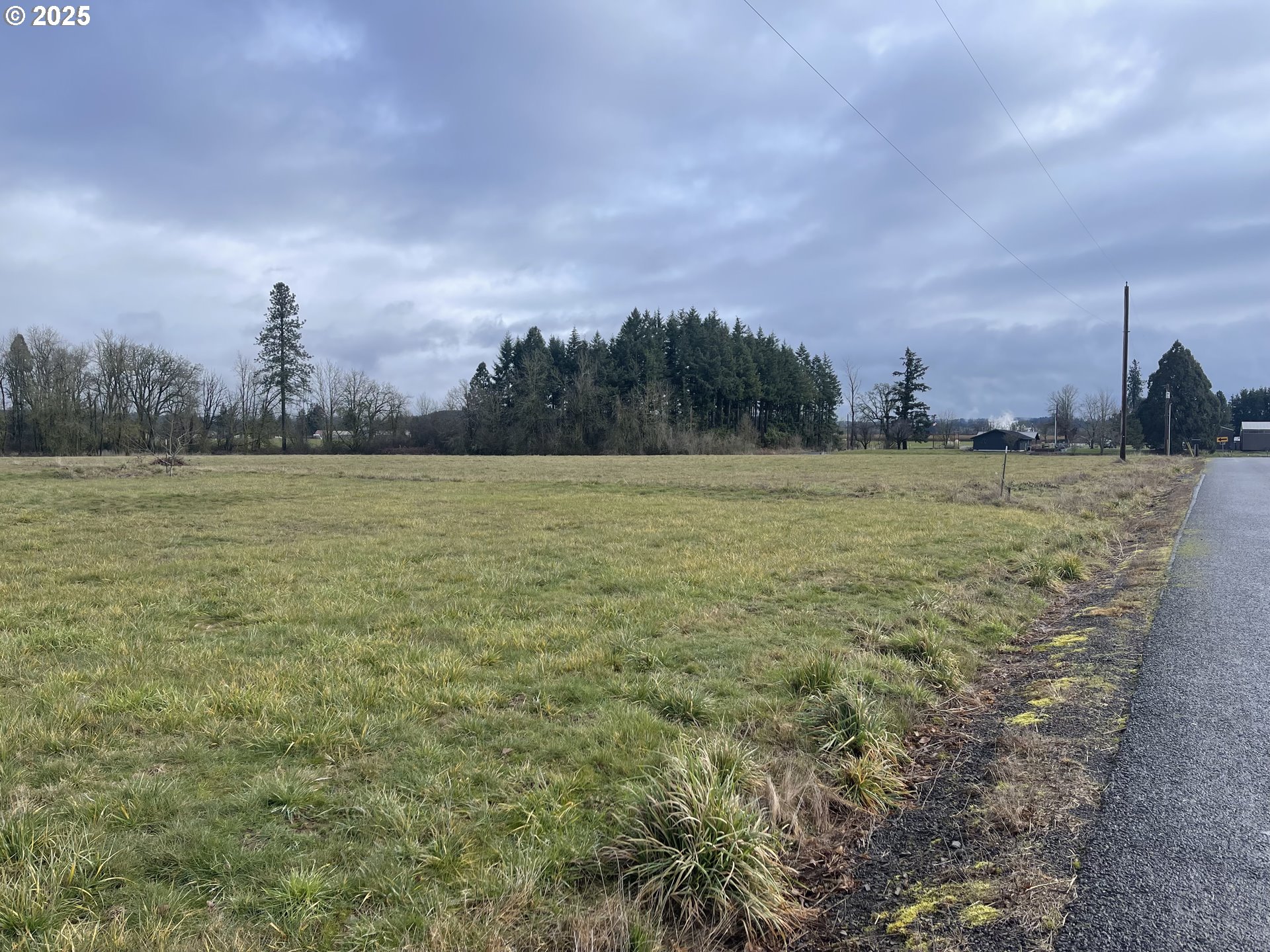12403 South Eby Road Canby, OR 97013 - Photo 3 of 26 a view of a field with an ocean and trees in the background