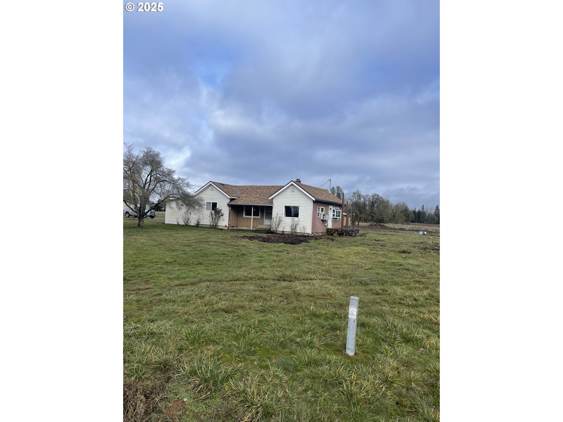 12403 South Eby Road Canby, OR 97013 - Photo 6 of 26 a front view of a house with a yard
