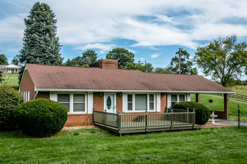 a front view of a house with a yard table and chairs