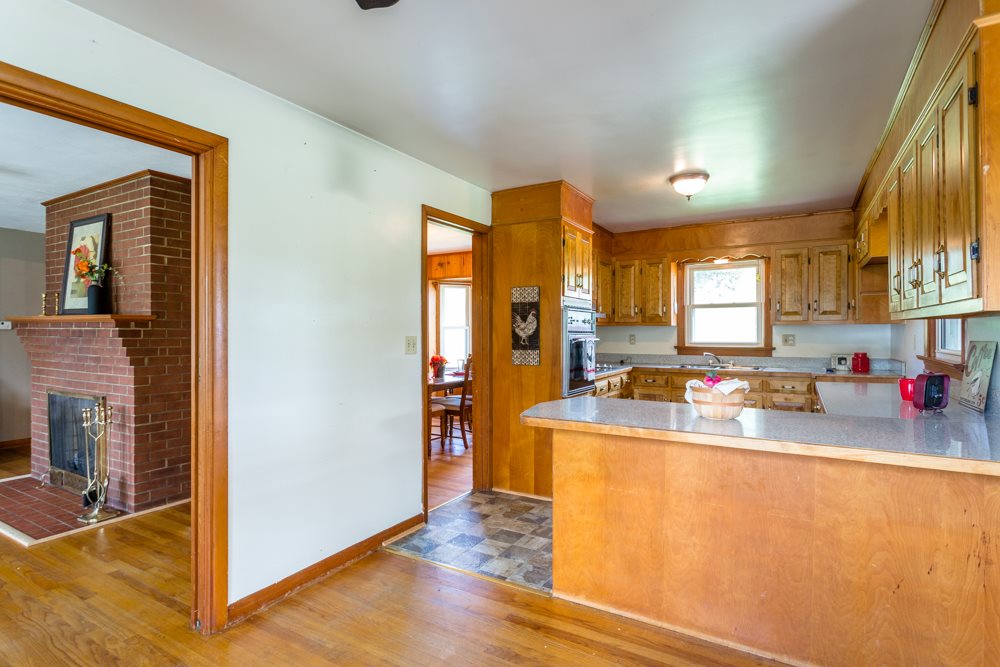 719 Middlebrook Road Staunton, VA 24401 - Photo 5 of 26 a kitchen with sink a refrigerator and wooden cabinets