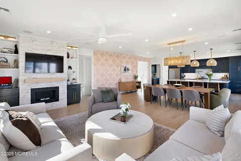 a living room with furniture kitchen and a fireplace