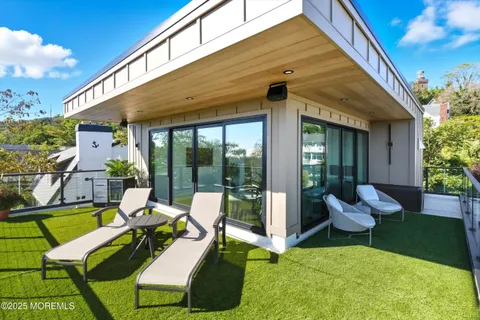 a view of a patio with chair and tables back yard of the house