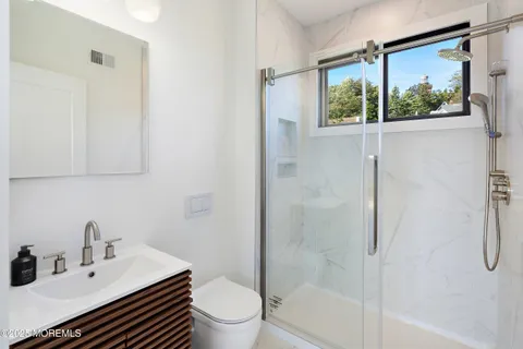 a bathroom with a sink toilet and shower