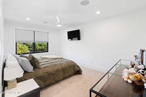 a bed sitting in a bedroom next to a window