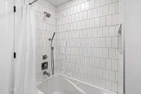 a bathroom with a bathtub and shower