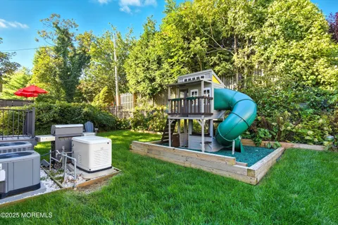 a view of a chair and table in the back yard of the house