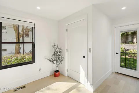 a view of entryway with window and wooden floor
